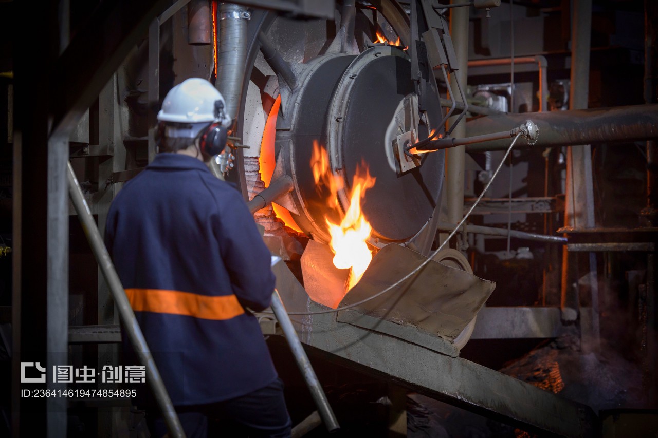 Steel worker pouring molten metal in steel foundry